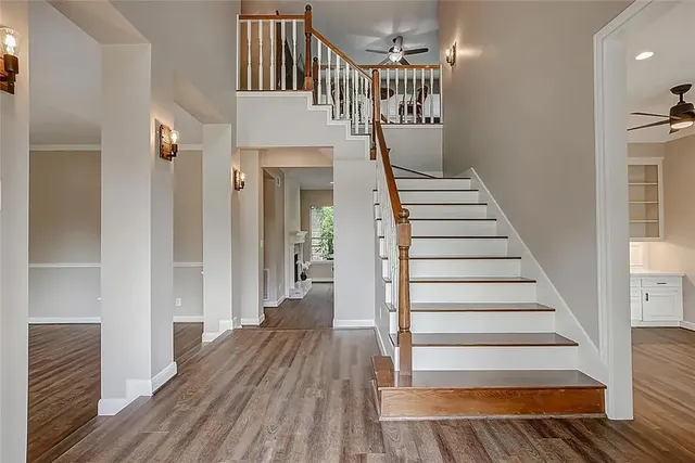 a view of entryway and hall with wooden floor