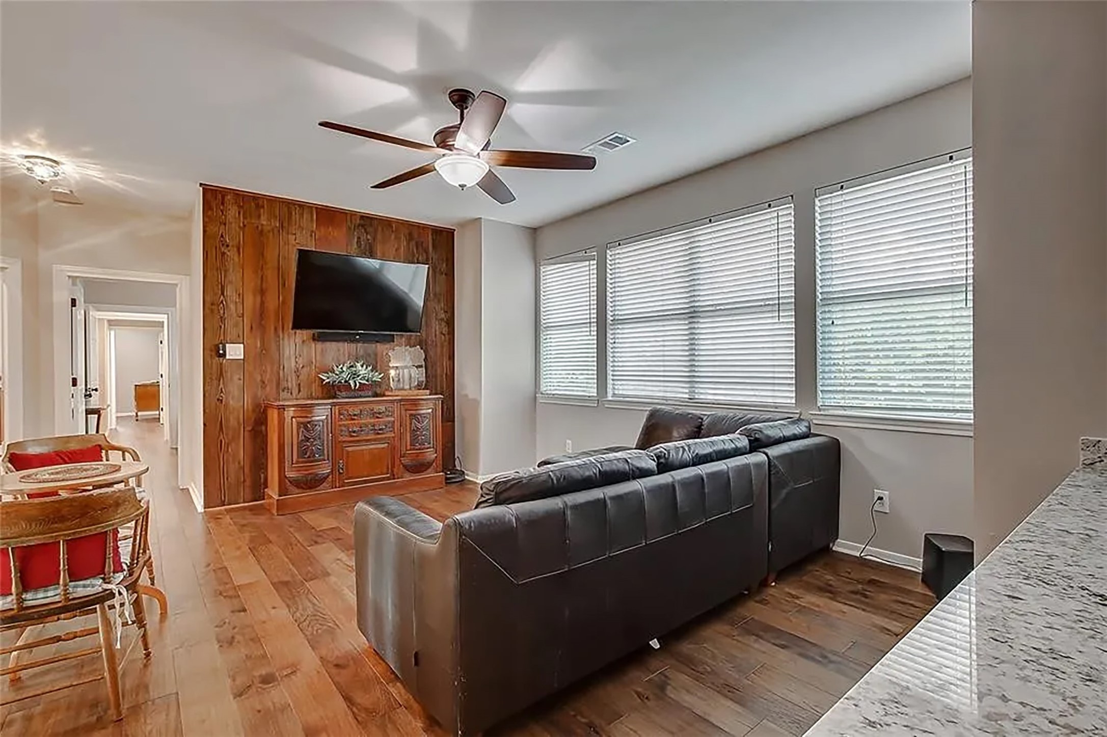 4421 Bowser Road Fulshear, TX 77441 - Photo 32 of 41 a living room with furniture a flat screen tv and a large window