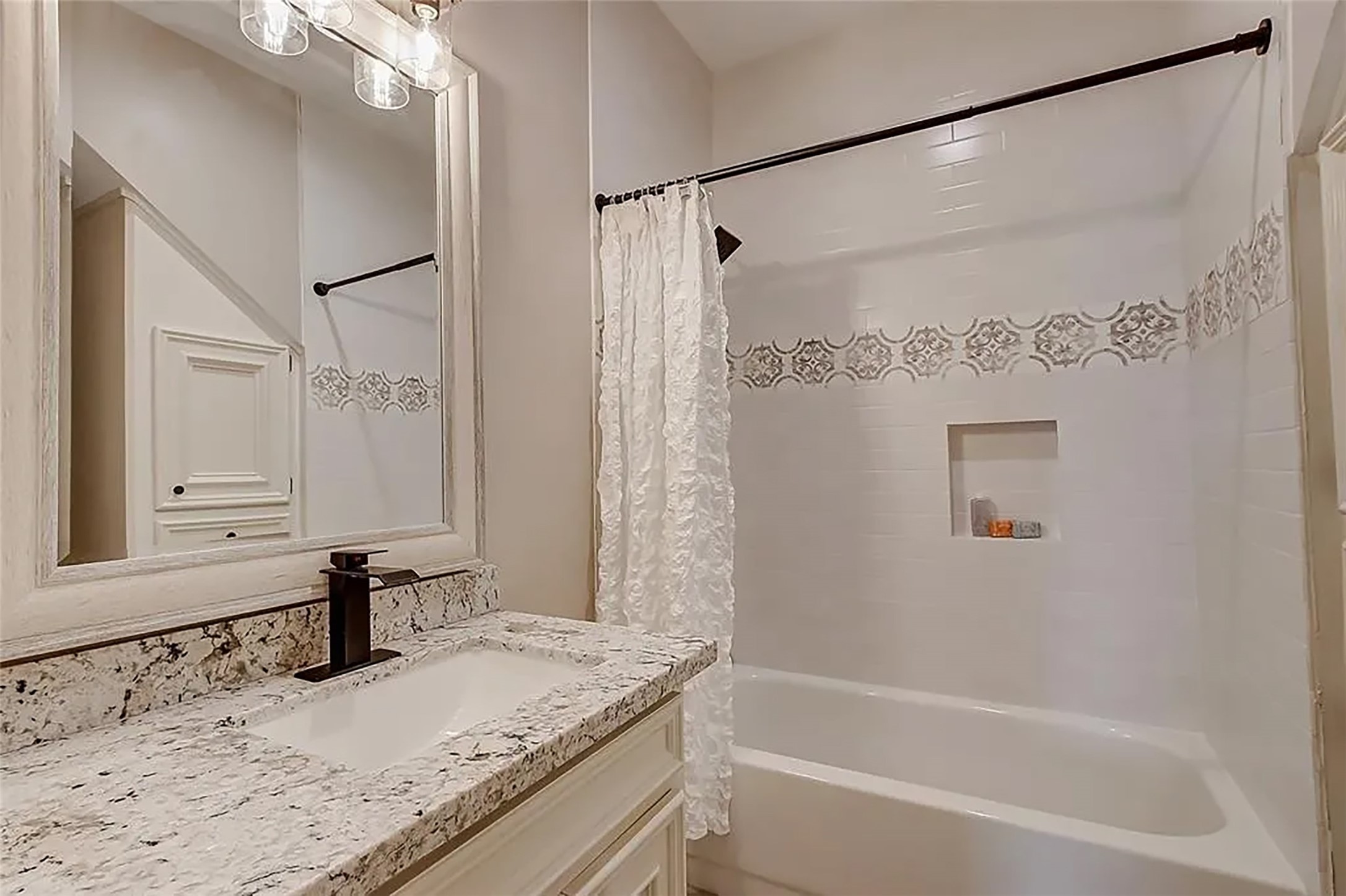 4421 Bowser Road Fulshear, TX 77441 - Photo 33 of 41 a bathroom with a granite countertop sink mirror and a bath tub