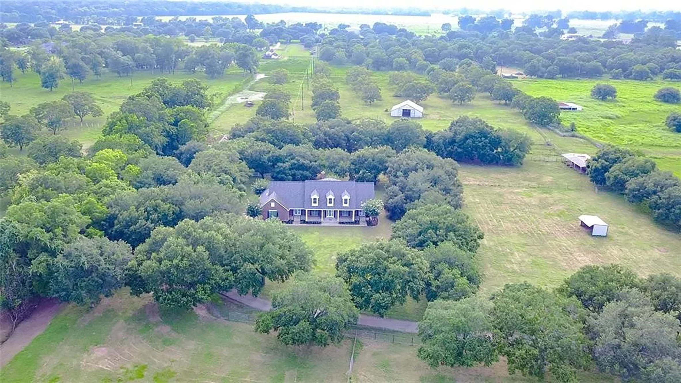 4421 Bowser Road Fulshear, TX 77441 - Photo 40 of 41 a view of a lake with huge green field and trees