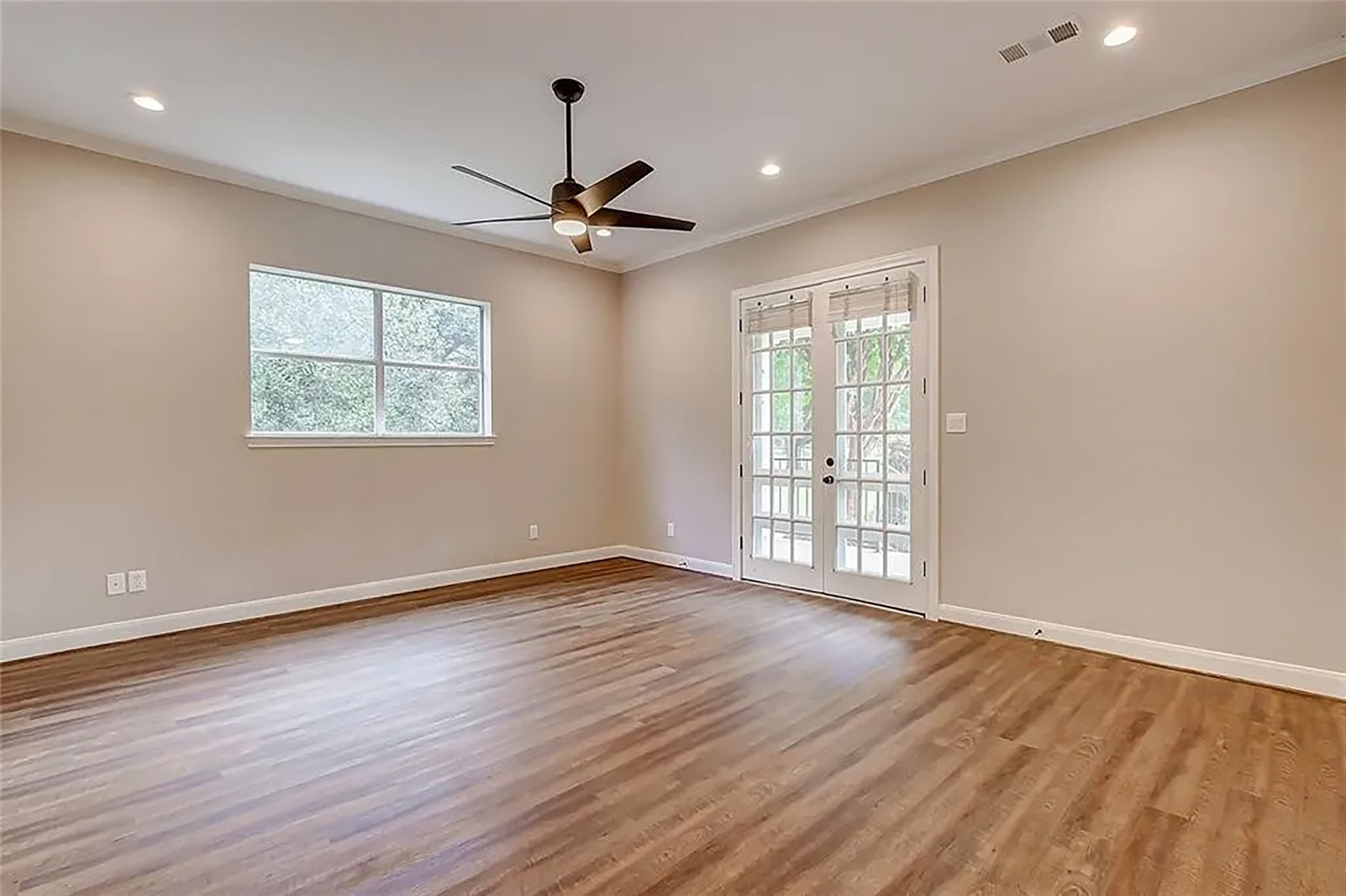4421 Bowser Road Fulshear, TX 77441 - Photo 10 of 41 a view of an empty room with wooden floor and a window