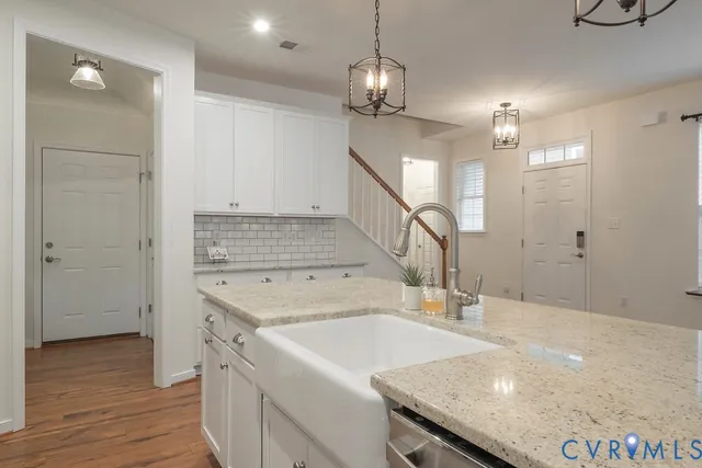 a view of a kitchen center island and stainless steel appliances