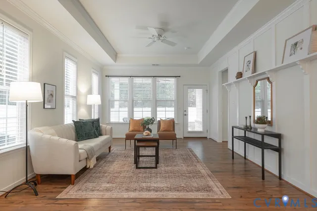 a living room with furniture and a potted plant on the table
