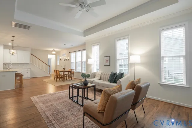 a living room with furniture and a wooden floor