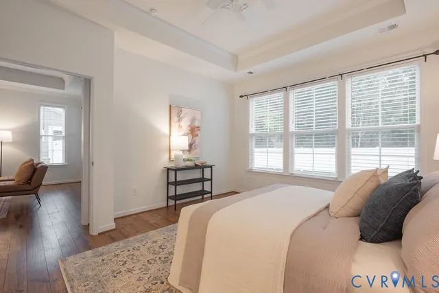 a bedroom with a bed and a large window