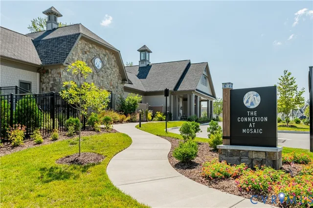 a view of a house with a yard and sitting area