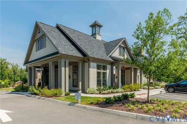 a front view of a house with a yard and garden