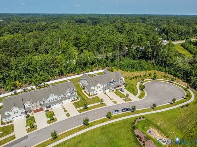 an aerial view of a swimming pool with a patio