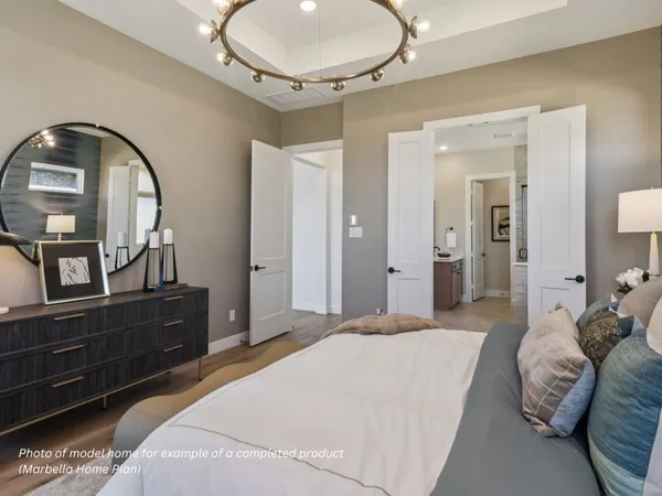 a bedroom with a bed and a mirror on dresser
