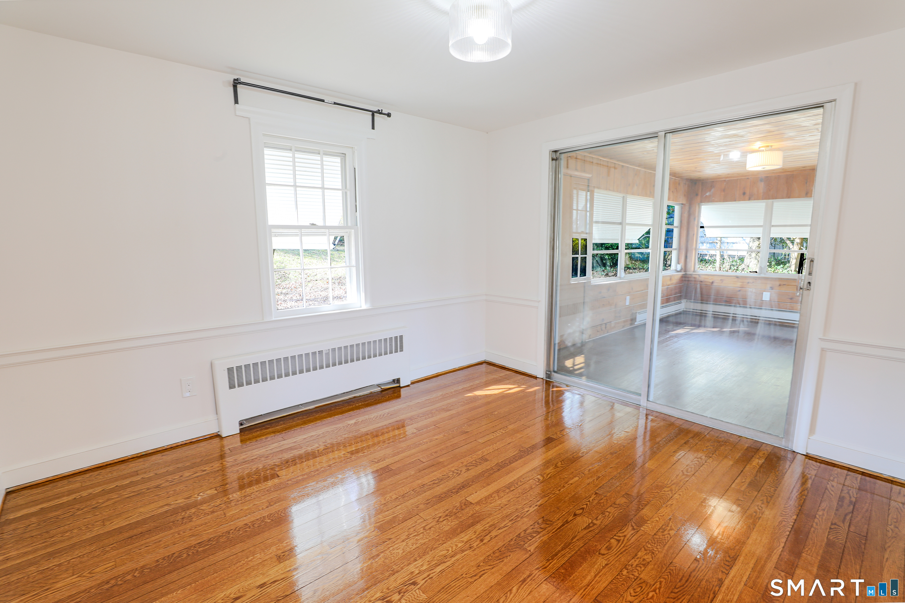 105 Hyde Road West Hartford, CT 06117 - Photo 12 of 25 a view of an empty room with wooden floor and a window