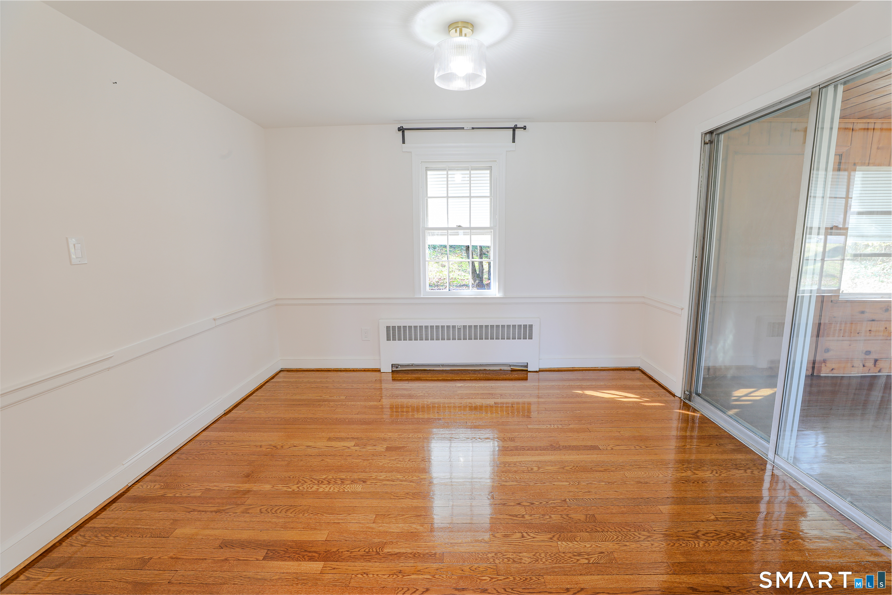 105 Hyde Road West Hartford, CT 06117 - Photo 14 of 25 a view of empty room with wooden floor and fan