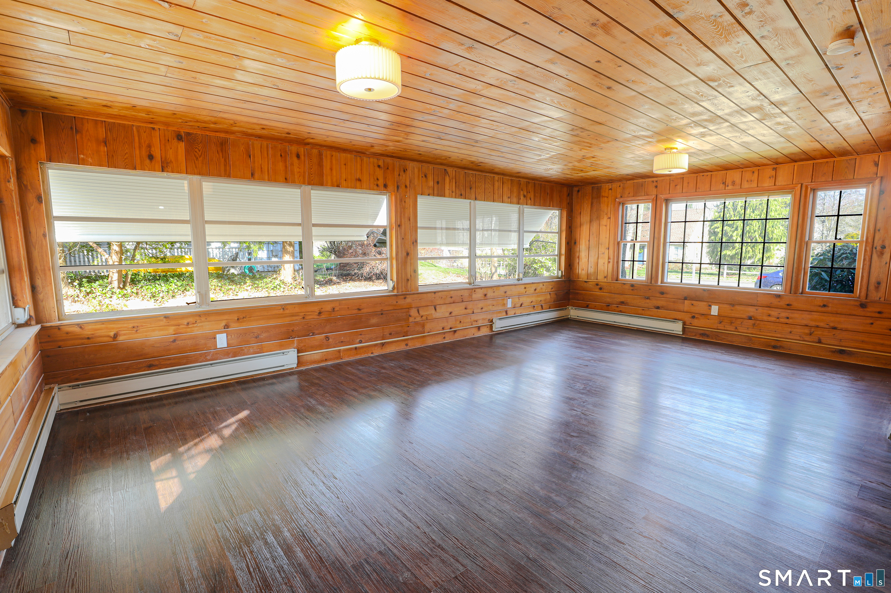105 Hyde Road West Hartford, CT 06117 - Photo 15 of 25 an empty room with wooden floor and windows