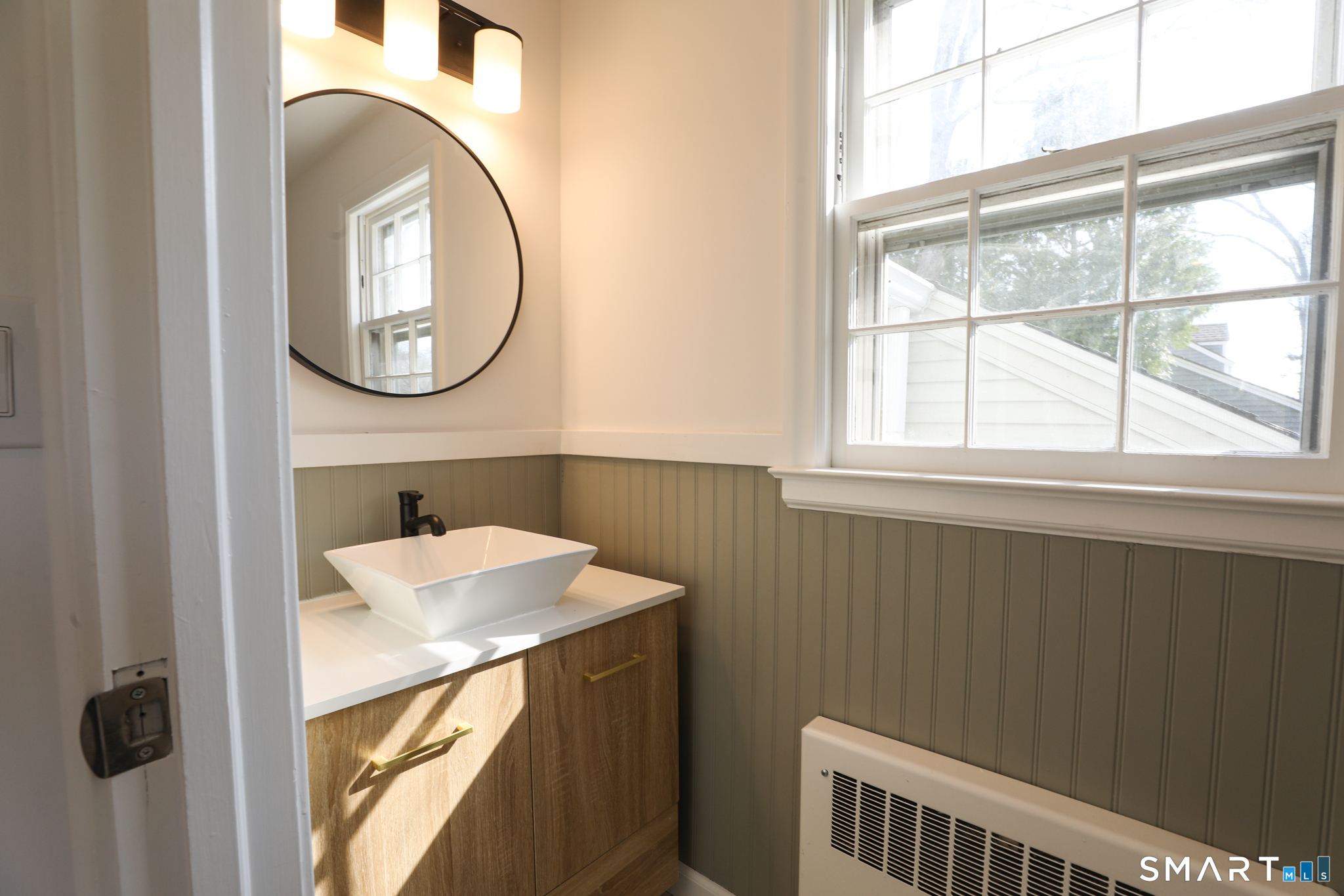 105 Hyde Road West Hartford, CT 06117 - Photo 16 of 25 a bathroom with a sink and a mirror