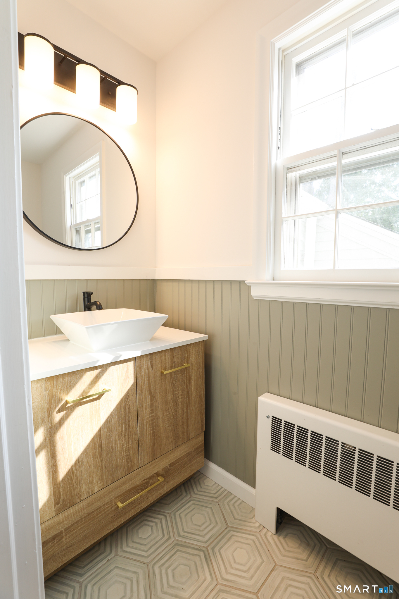 105 Hyde Road West Hartford, CT 06117 - Photo 17 of 25 a bathroom with a sink and a mirror