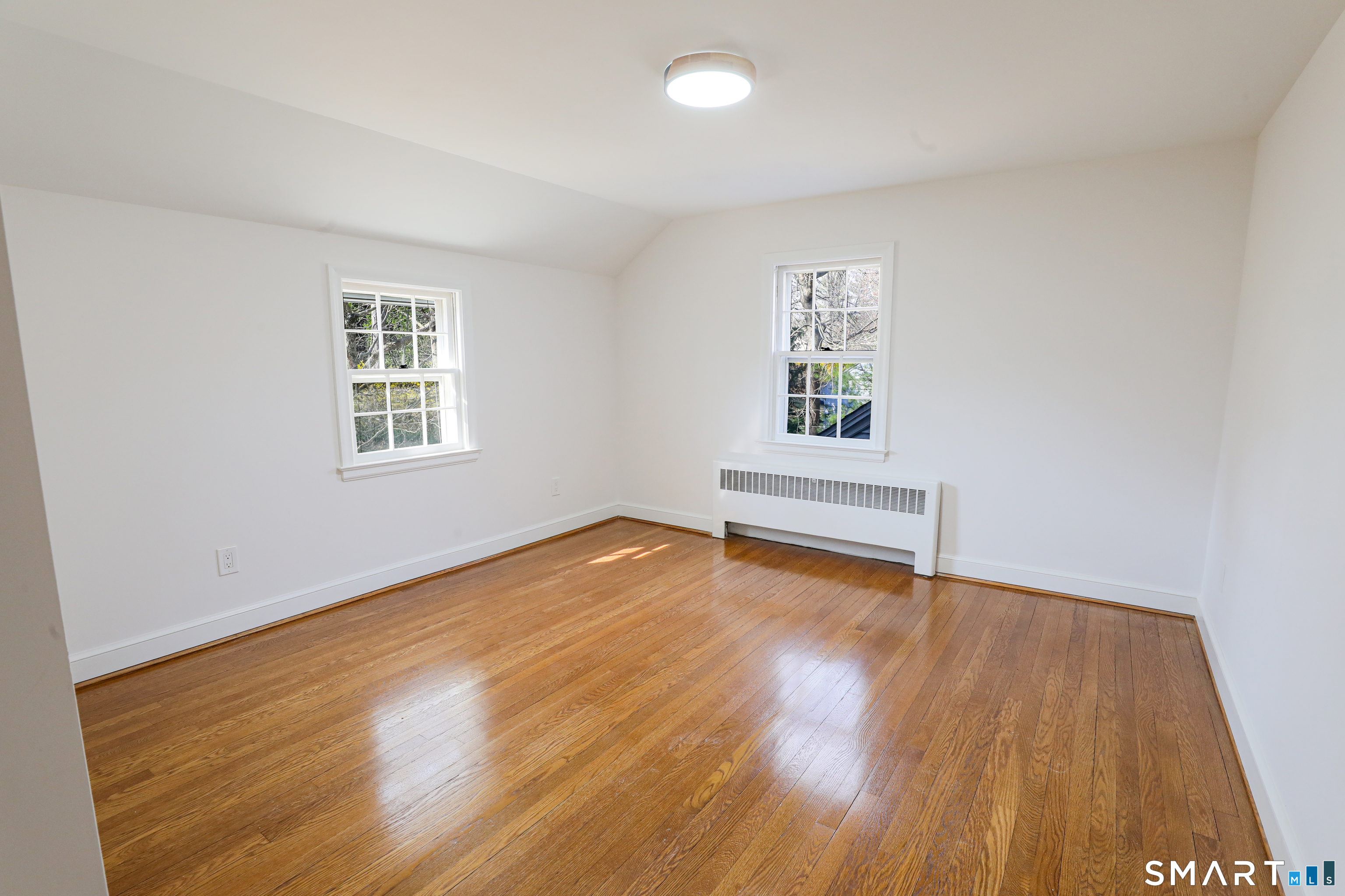 105 Hyde Road West Hartford, CT 06117 - Photo 20 of 25 an empty room with wooden floor and windows