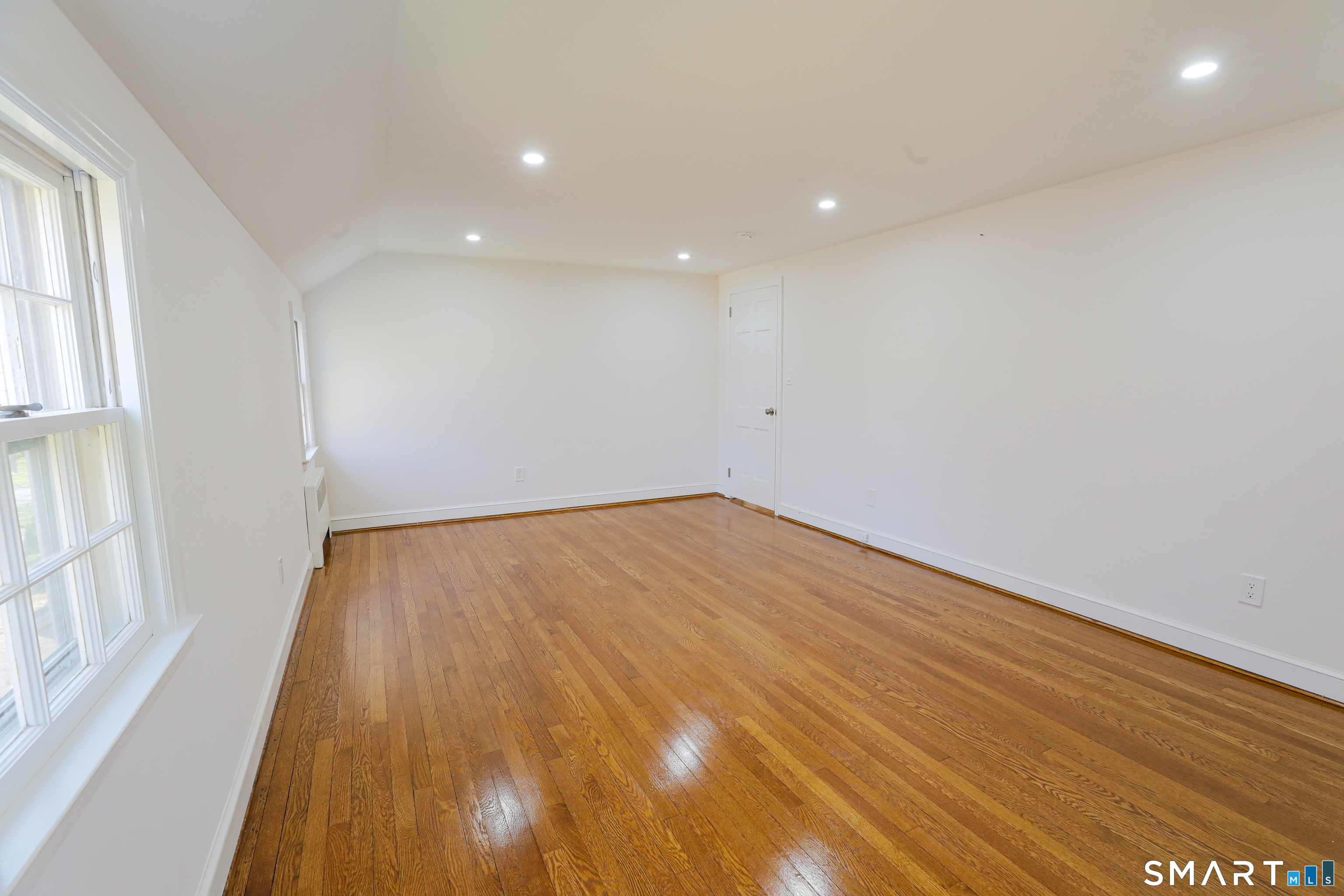 105 Hyde Road West Hartford, CT 06117 - Photo 21 of 25 a view of empty room with wooden floor and fan