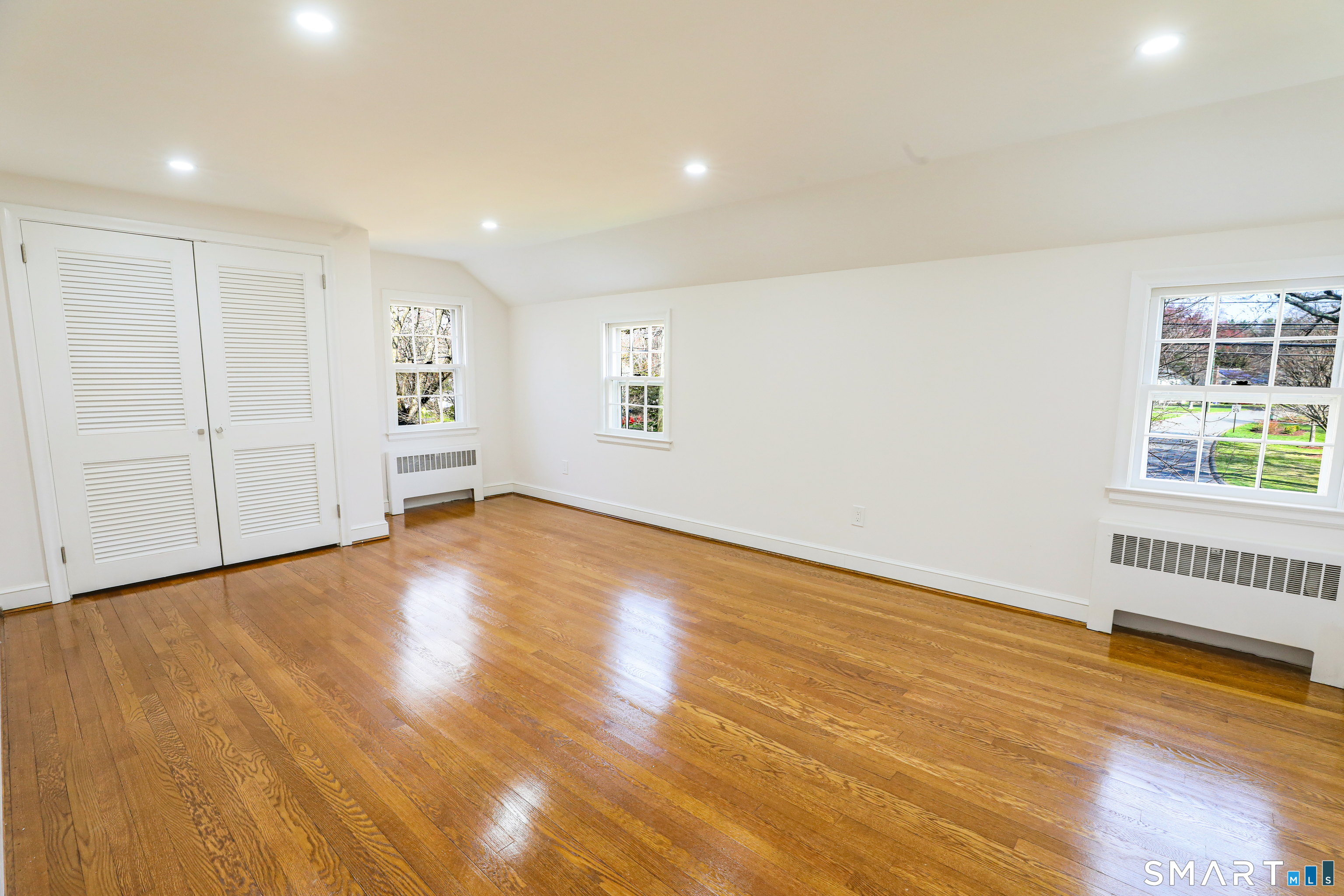 105 Hyde Road West Hartford, CT 06117 - Photo 22 of 25 an empty room with wooden floor and windows