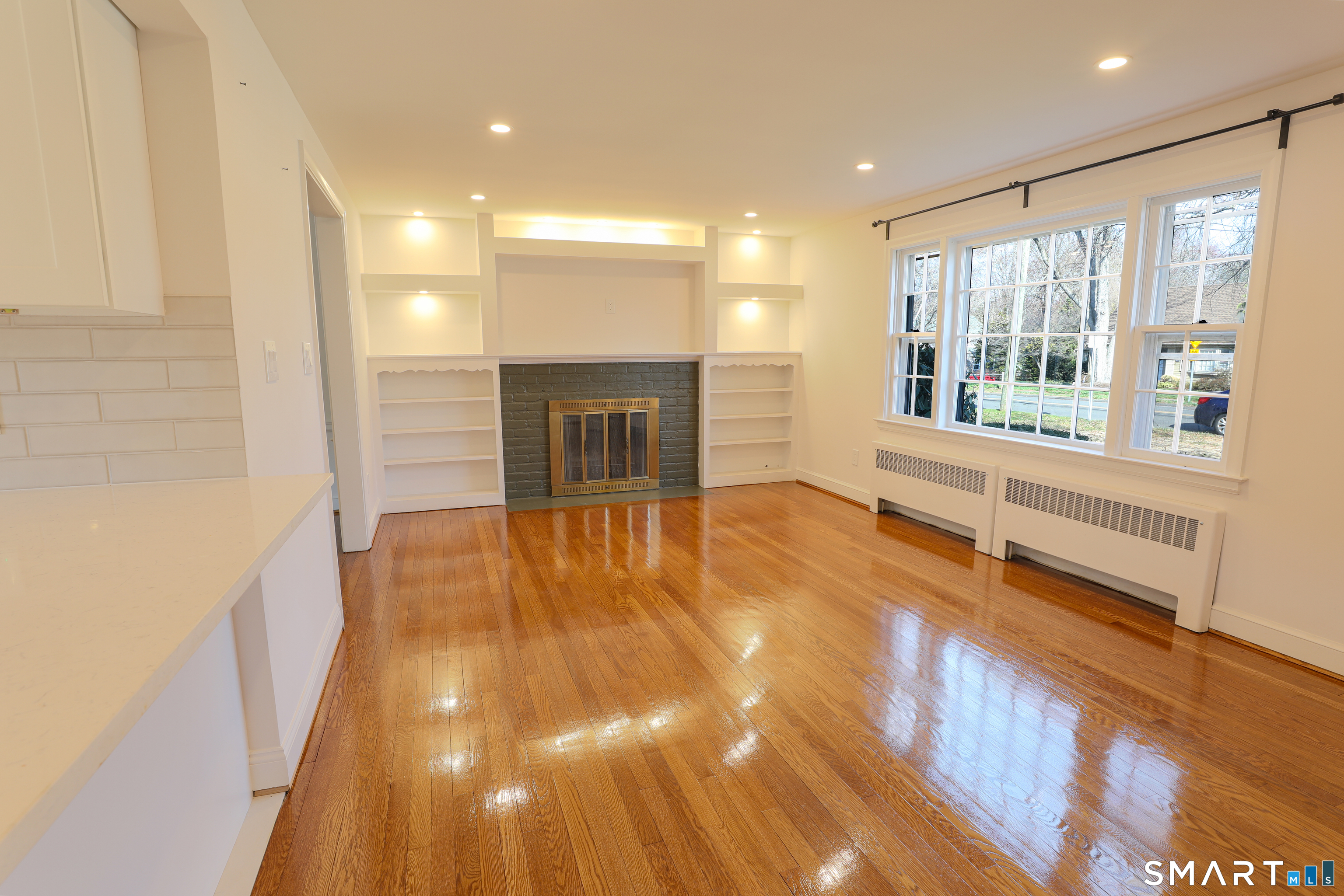 105 Hyde Road West Hartford, CT 06117 - Photo 6 of 25 a view of an empty room with a fireplace and a window