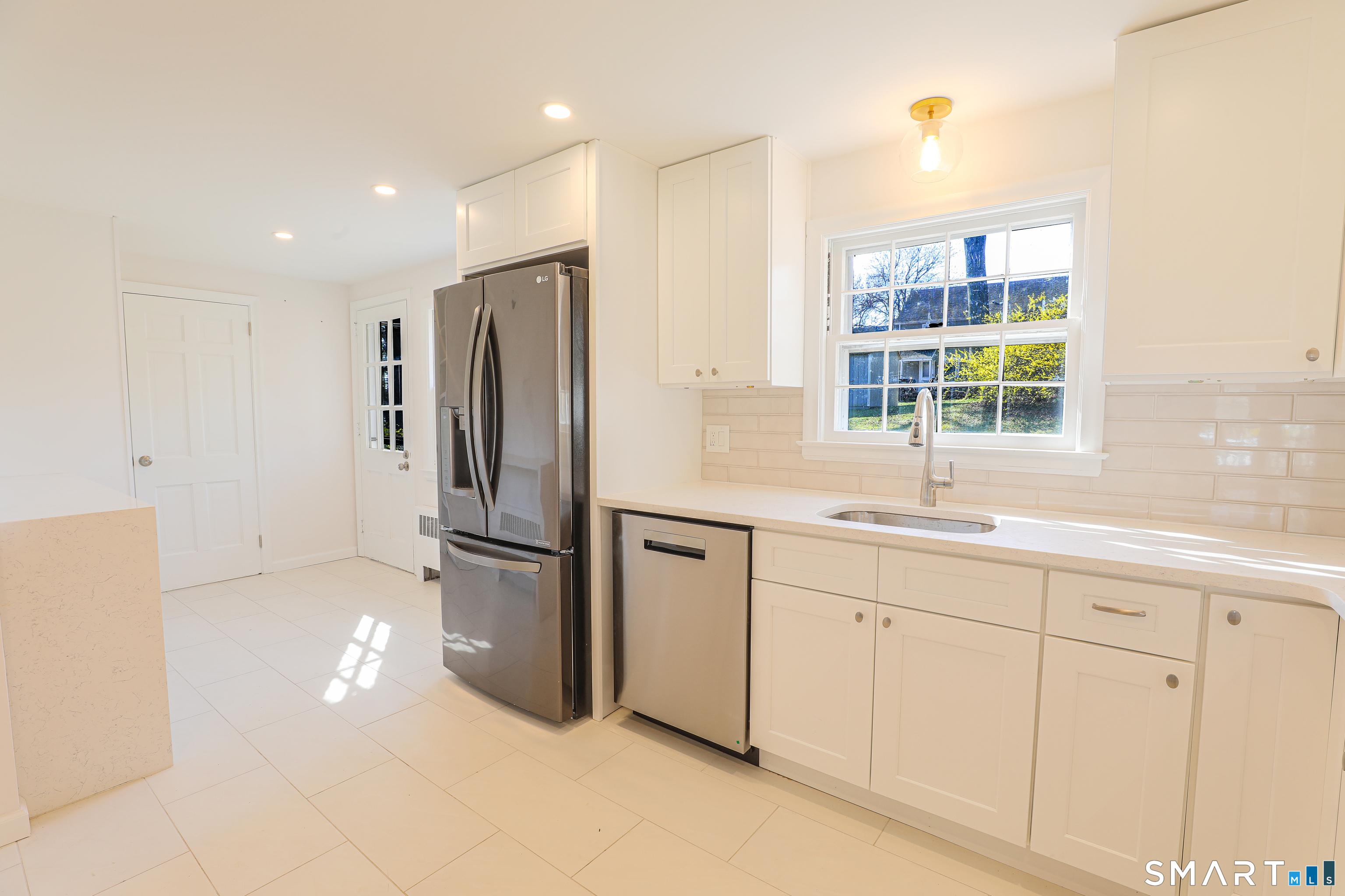 105 Hyde Road West Hartford, CT 06117 - Photo 7 of 25 a kitchen with a refrigerator and a sink