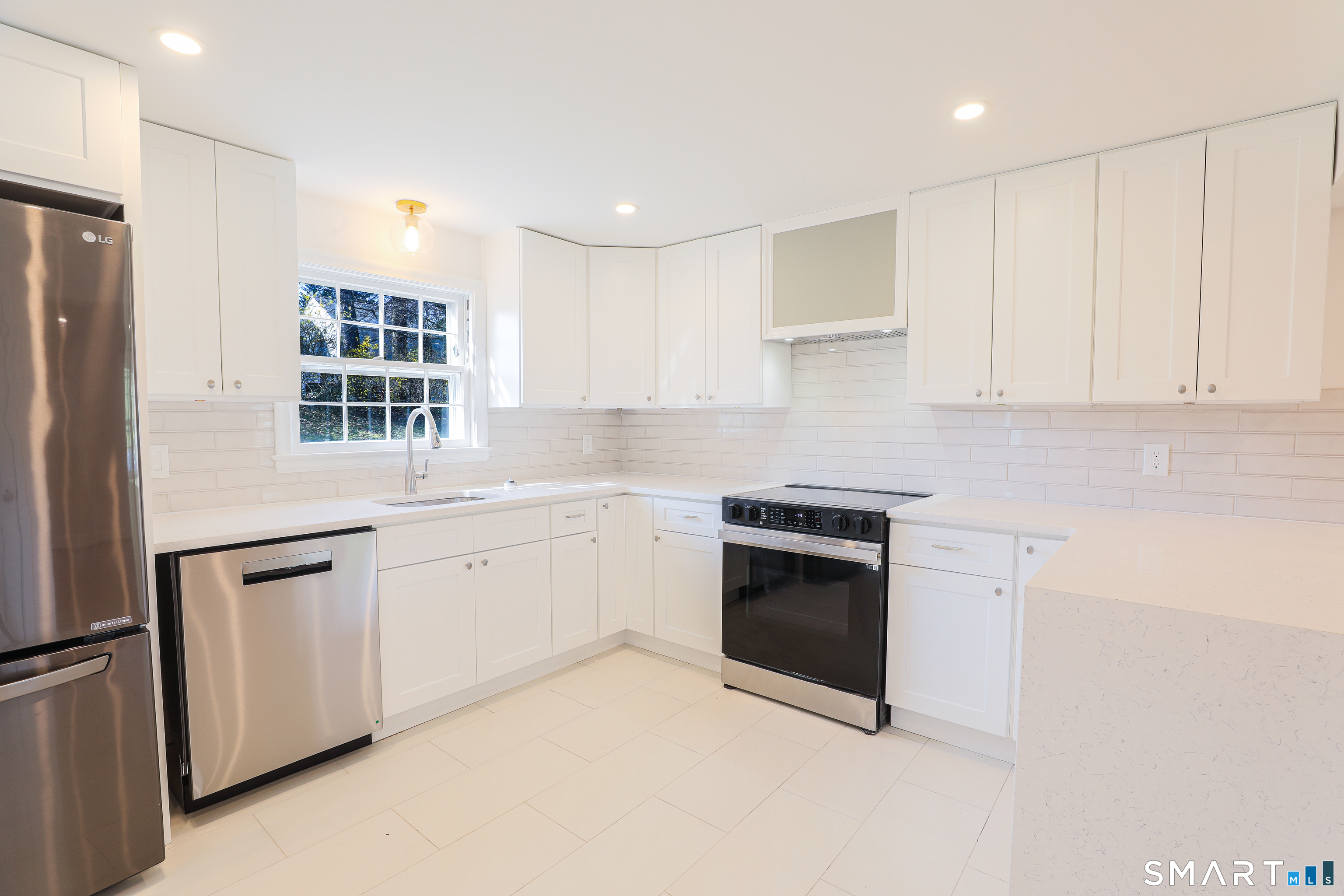 105 Hyde Road West Hartford, CT 06117 - Photo 9 of 25 a kitchen with granite countertop white cabinets and stainless steel appliances