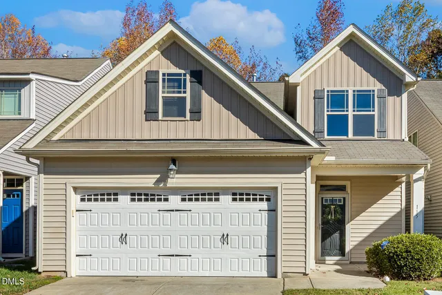 a view of a house with a garage and balcony