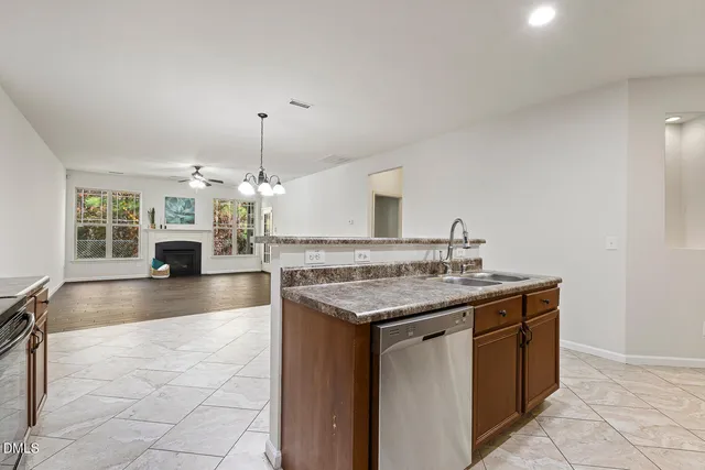 a kitchen with granite countertop a sink and a stove