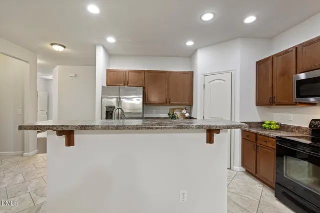a kitchen with stainless steel appliances granite countertop a sink stove and microwave