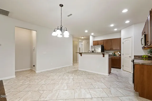 a view of a kitchen with microwave and cabinets