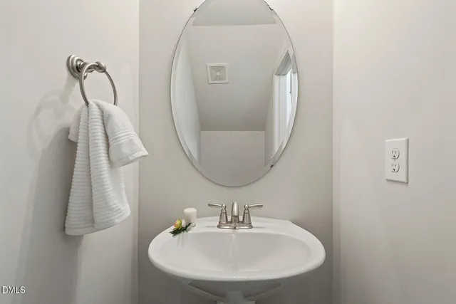 a bathroom with a sink and mirror