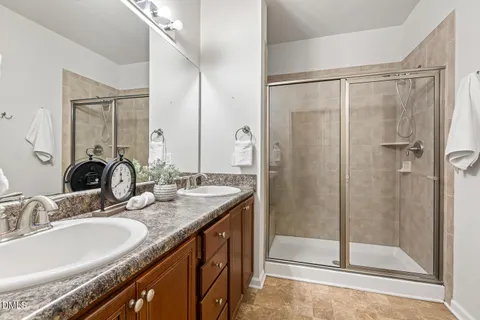 a bathroom with a granite countertop sink mirror and shower