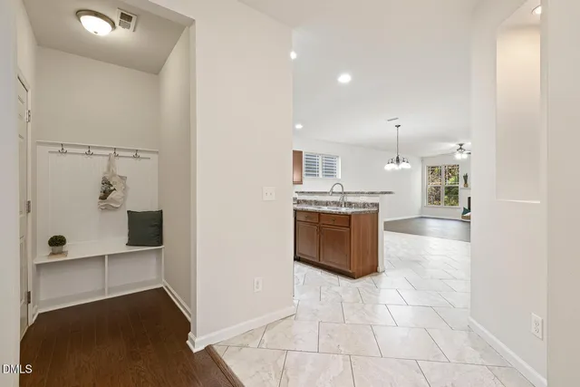 a large white kitchen with a stove a sink and a refrigerator