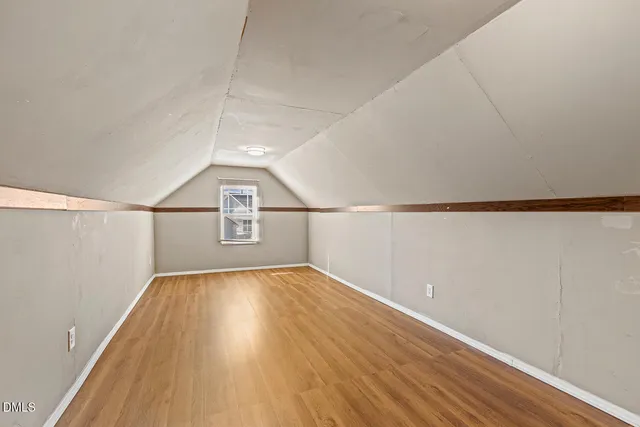 a view of a room with wooden floor and white walls