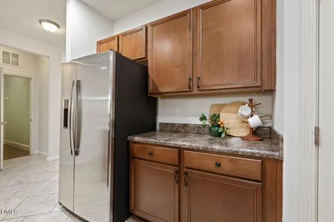 a kitchen with stainless steel appliances granite countertop cabinets and refrigerator