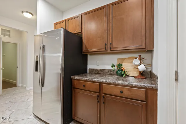 a kitchen with stainless steel appliances granite countertop cabinets and refrigerator