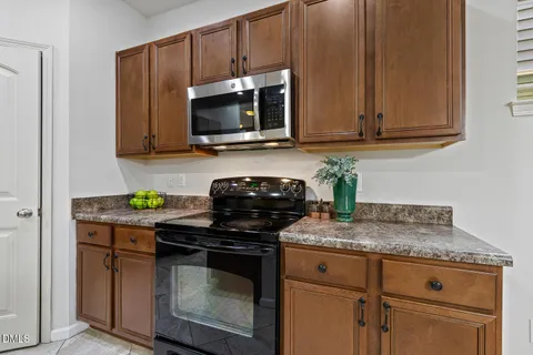a kitchen with stainless steel appliances granite countertop a stove and a microwave