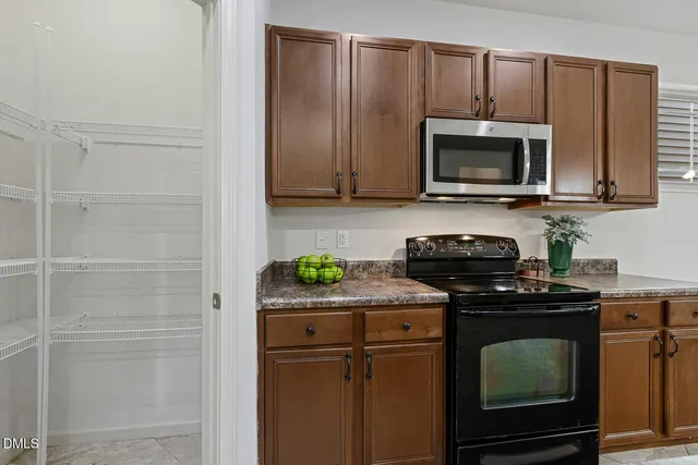 a kitchen with a stove microwave and sink