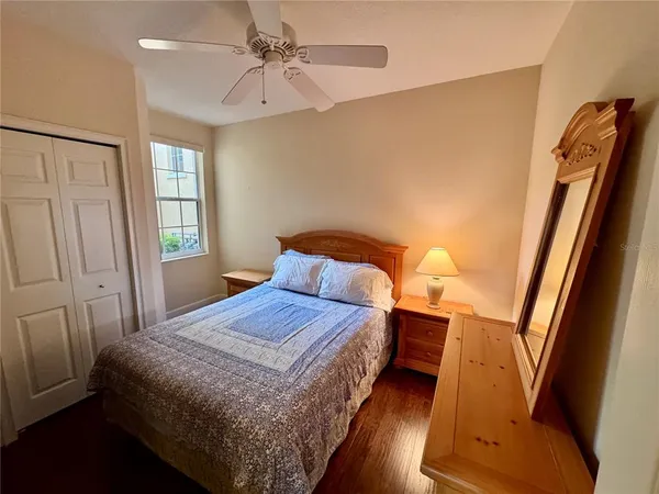 a bedroom with a bed and wooden floor
