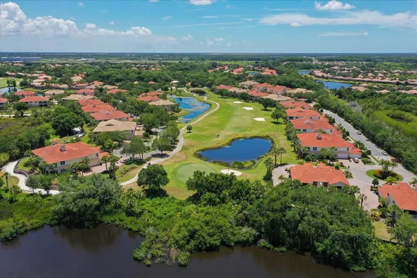 an aerial view of residential houses with outdoor space and ocean view