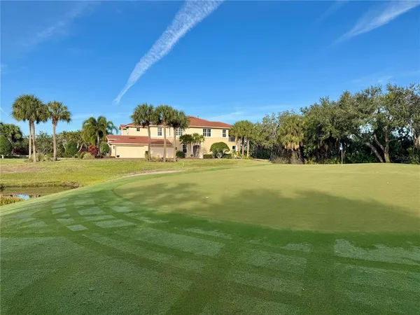 a front view of a house with a big yard