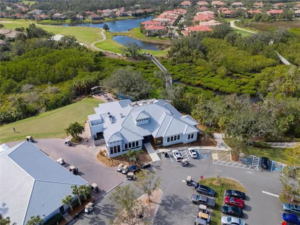 an aerial view of a house with garden space and lake view