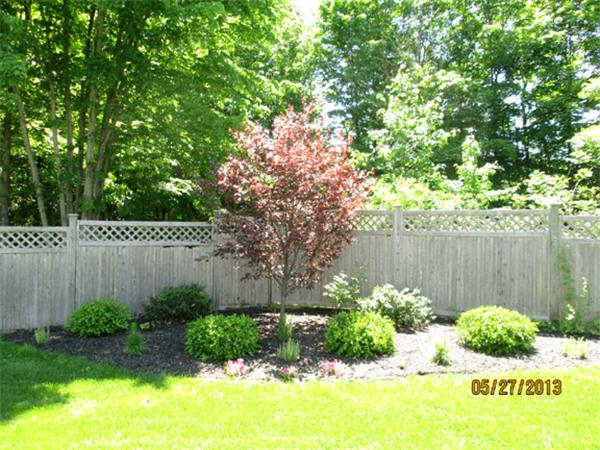 31 Bridge Road Northampton, MA 01062 - Photo 19 of 20 a view of a backyard with plants and wooden fence