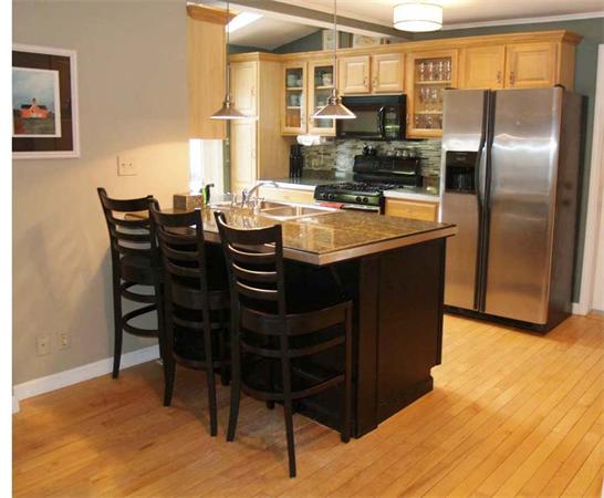 31 Bridge Road Northampton, MA 01062 - Photo 6 of 20 a kitchen with stainless steel appliances granite countertop a table chairs and a refrigerator
