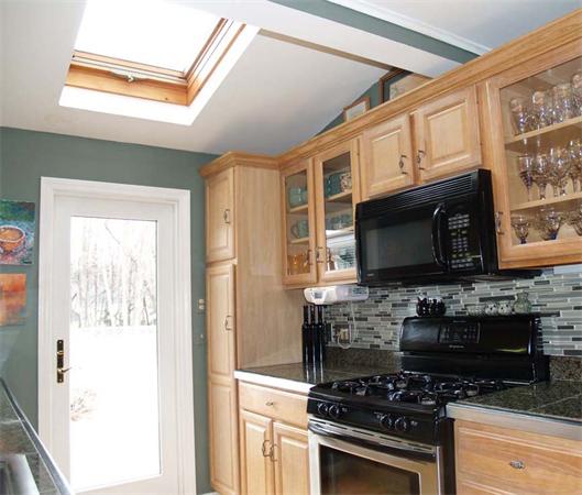 31 Bridge Road Northampton, MA 01062 - Photo 7 of 20 a kitchen with stainless steel appliances a stove a microwave and cabinets
