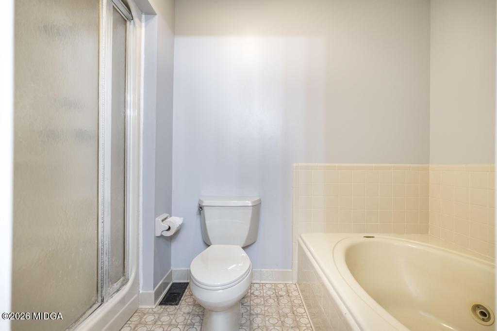 3710 Sandy Circle Macon, GA 31216 - Photo 26 of 44 a bathroom with a toilet and a bathtub