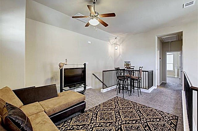 14001 Avery Ranch Boulevard, Unit 801 Austin, TX 78717 - Photo 13 of 26 A versatile loft space offers comfortable living with carpeted floors and a ceiling fan.