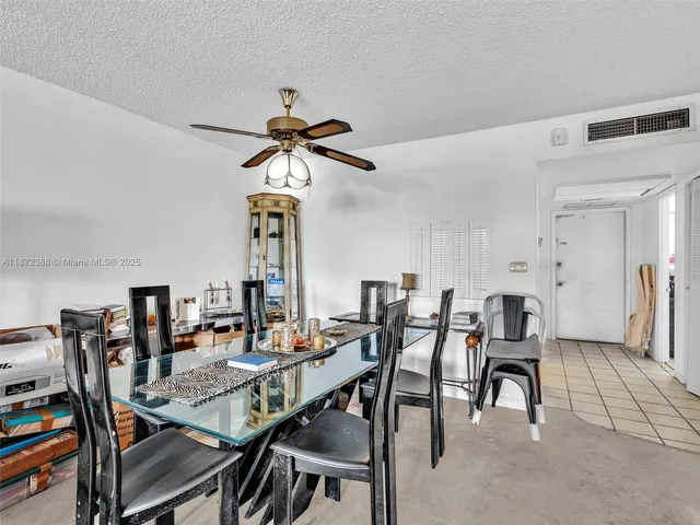 a living room with furniture a rug and a table