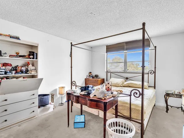 a bathroom with a granite countertop toilet sink and mirror