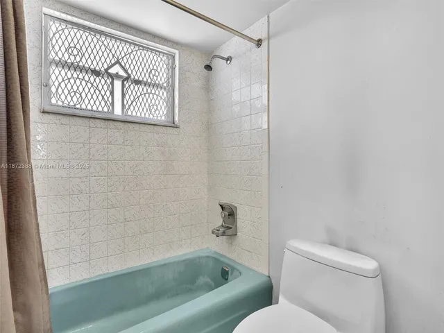 a utility room with cabinets washer and dryer