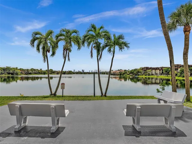 a view of building with cars parked in front of it