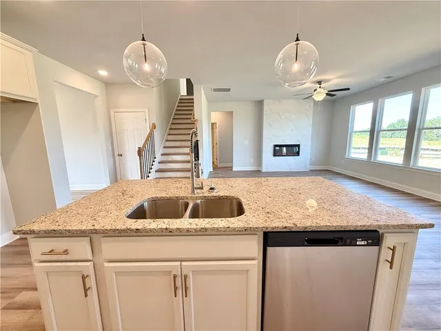 a kitchen with a sink a faucet cabinets and chandelier